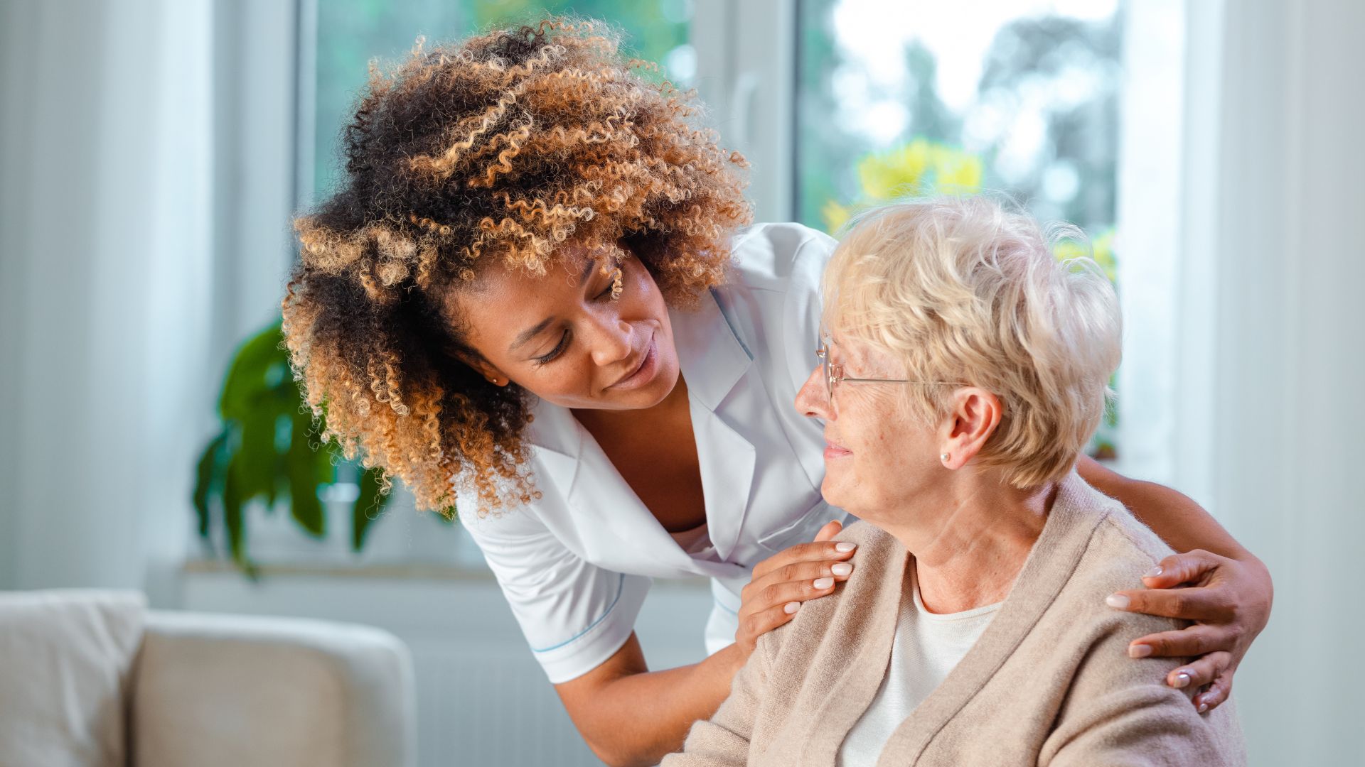 Home nurse taking care of a senior woman